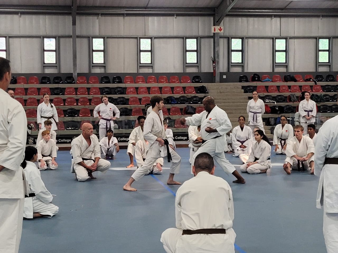 Two karateka demonstrating kumite while others watch during the September 2025 gasshuku