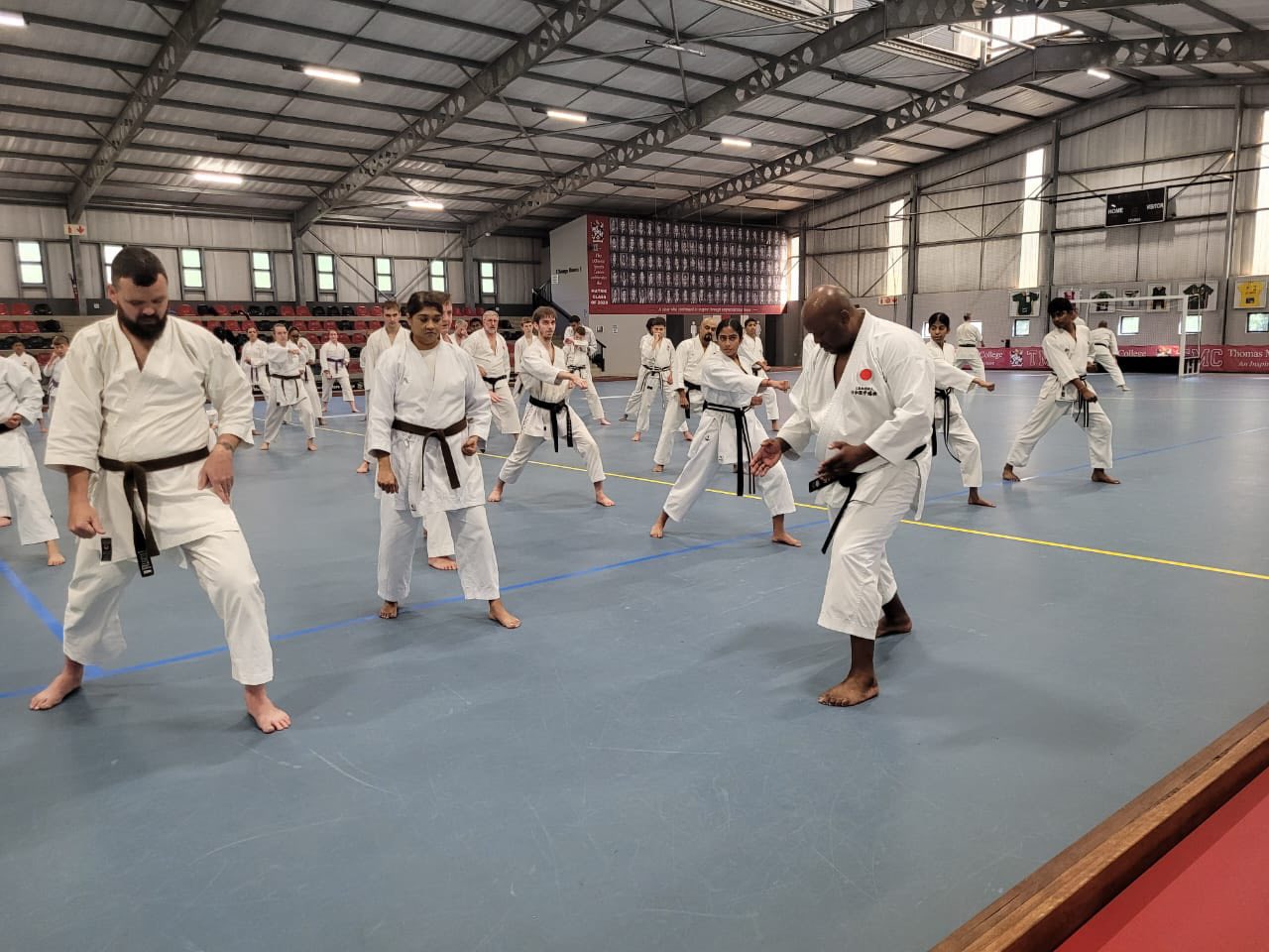 Karateka practising stances in formation at the September 2025 gasshuku