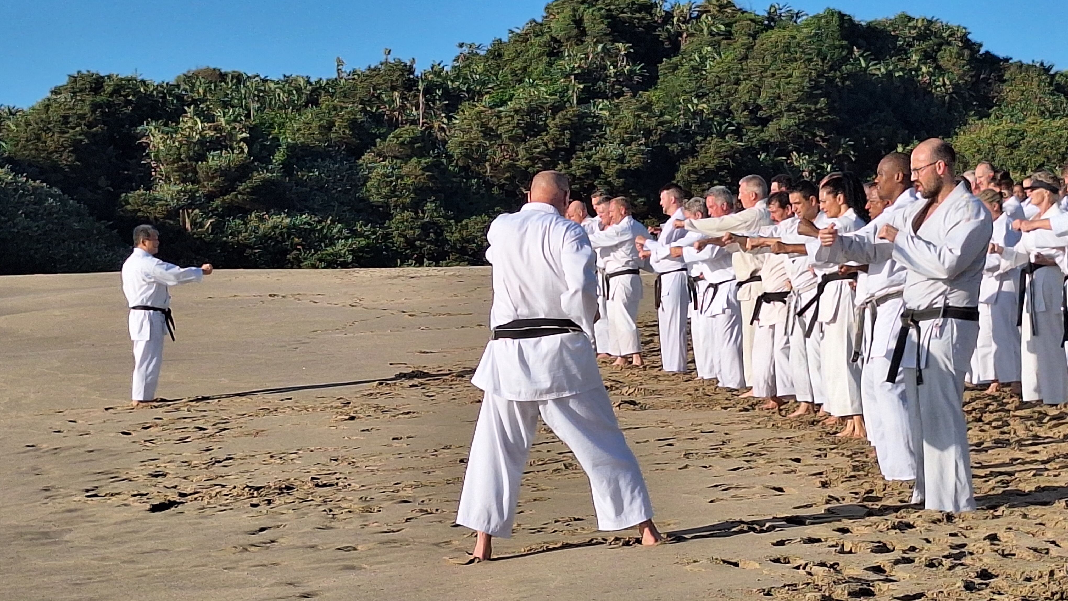 Instructor leading punch practice on the beach during the December 2025 gasshuku