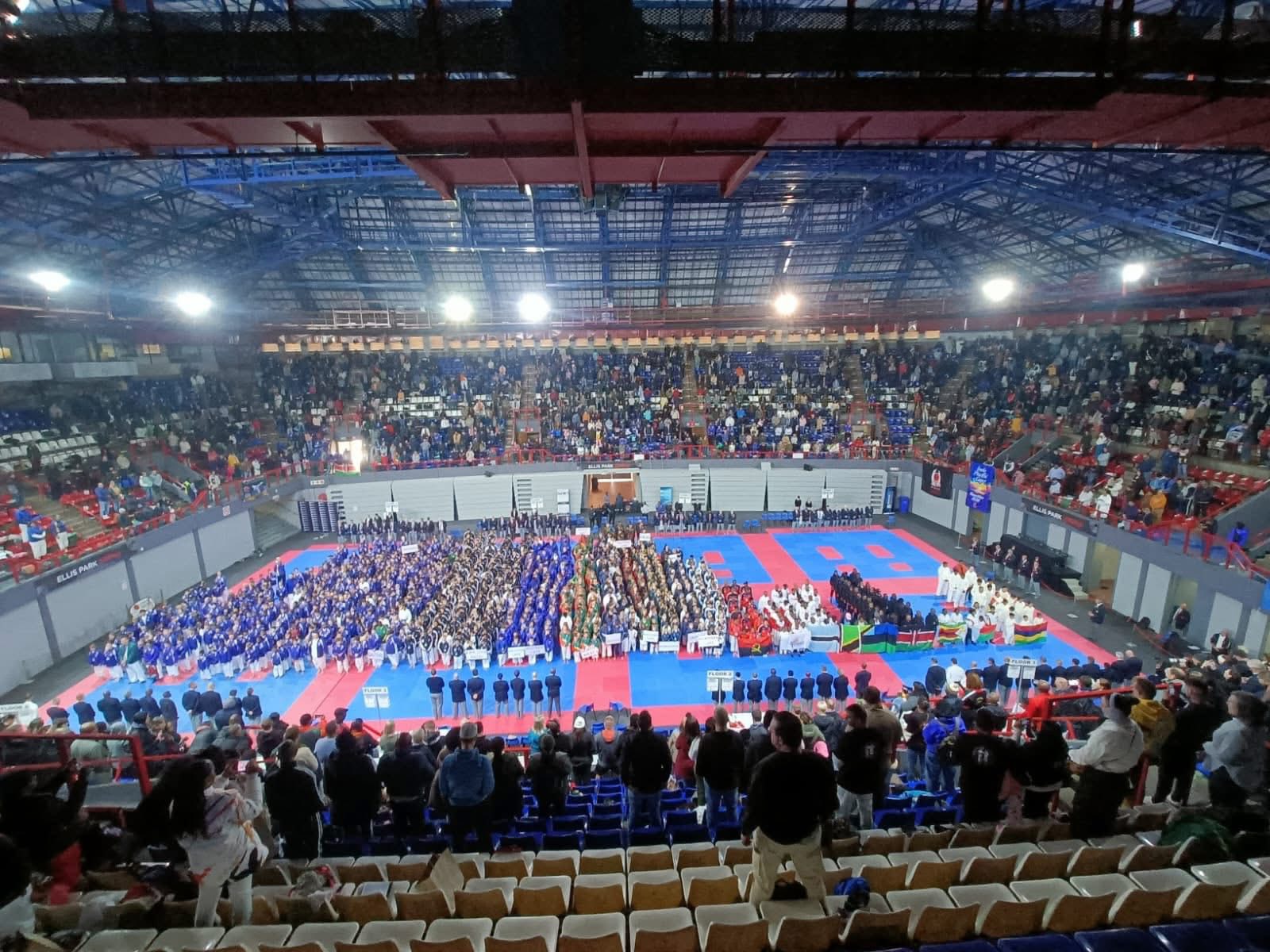 Wide view of Ellis Park Arena during the opening ceremony with hundreds of competitors on the mats